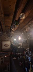 a restaurant with a bar with bottles and lights at Locanda Toronto in Moriago della Battaglia