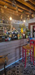 a restaurant with a bar with a table and chairs at Locanda Toronto in Moriago della Battaglia