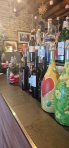 a row of bottles of wine sitting on a counter at Locanda Toronto in Moriago della Battaglia