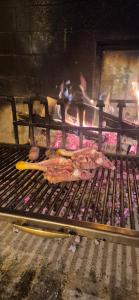 a person is cooking food on a grill at Locanda Toronto in Moriago della Battaglia