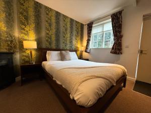 Postel nebo postele na pokoji v ubytování The Gillygate Inn