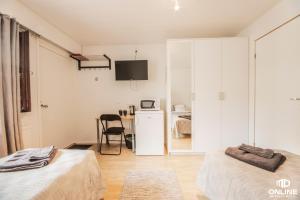 una camera con due letti e un tavolo con una sedia di Motelli Online Oy a Porvoo