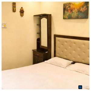 a bedroom with a bed and a large mirror at Kiashna Villa No 32, Pool Villa near Igatpuri in Khardi +14 photos