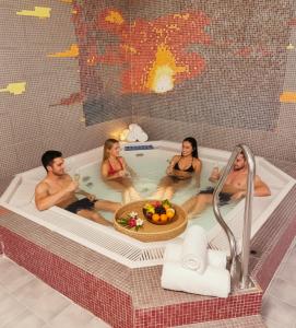 a group of people sitting in a bath tub at Hotel Batzenhäusl in Innsbruck