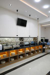 een keuken met houten planken en een tv aan de muur bij Vatan Hotel in Doesjanbe