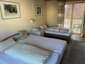 a room with two beds and a window at Apartment am Rathaus 3SZ in Rödermark