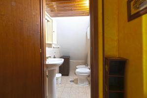 a bathroom with a white toilet and a sink at Al Rifugio Nel Borgo in Vitorchiano +18 photos
