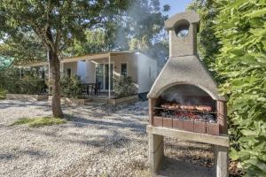 a brick oven in front of a house at Camping Village Torre Pendente in Pisa