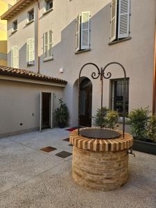 a building with a fountain in front of it at Palazzo Glicine in Cotignola