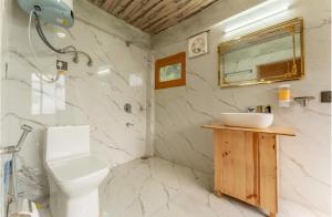 a bathroom with a sink and a toilet and a mirror at The nature view A shape tree cottage in Banjār