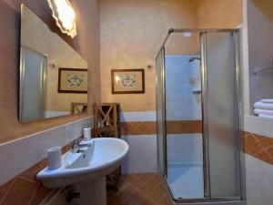 a bathroom with a sink and a shower at BoscoLago apartment Lake Iseo & Franciacorta in Iseo +24 photos