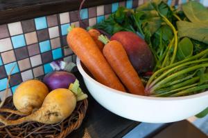 a bowl of vegetables sitting next to a bowl of fruit at Guest House KITOEDA in Nikko +9 photos