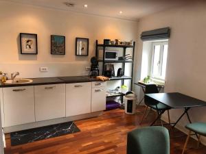 a kitchen with a sink and a table in a room at Ty Kéréon - Le cocon urbain in Quimper