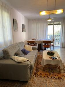 a living room with a couch and a table at La Casa del bosque in Valencia