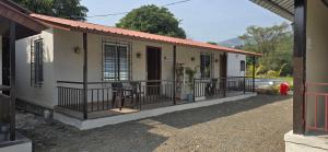a small house with a balcony and a red fire hydrant at Amrutvel Resort in Pune