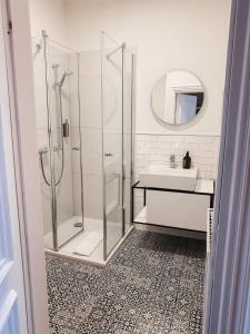 a bathroom with a shower and a sink at Momento Heidkrug in Lüneburg +21 photos