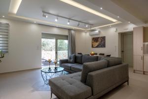 a living room with a couch and a table at Pasithea Villas in Neokhórion