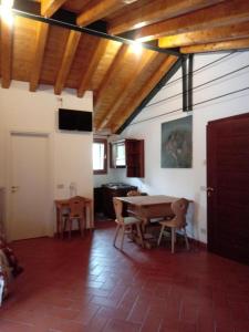 a living room with a wooden table and chairs at Locazione da nonna Gusta in Vittorio Veneto
