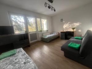 a living room with a couch and a flat screen tv at Pokoje Metro Imielin in Warsaw