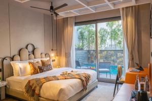 a bedroom with a large bed and a balcony at SaffronStays Boudhi Tree Villas in Rishīkesh +64 photos