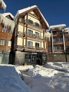 a building covered in snow with icicles on it at New Gudauri Studio N207 in Suites! in Gudauri