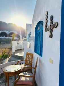 a patio with chairs and a table and a window at palma beach camp nuwibae in Nuweiba