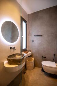 a bathroom with a tub and a toilet and a sink at KYAN Syros in Liaropá +11 photos