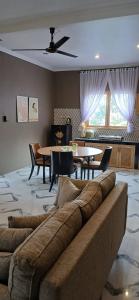 a living room with a couch and a table at Villa Panorama Amed in Ambat