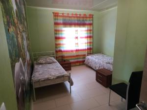 a small room with two beds and a window at "Fürstenhaus-OG" 3-ZKBB Hofgeismar-Zentrum! in Hofgeismar