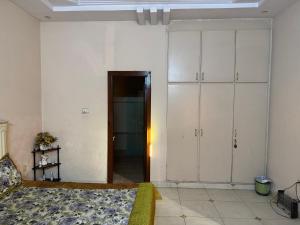a bedroom with a bed and a closet and a door at Musa house D ground in Faisalabad +3 photos