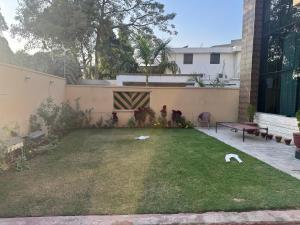 a small backyard with a yard with a fence at Musa house D ground in Faisalabad