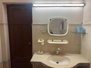 a bathroom with a sink and a mirror at Musa house D ground in Faisalabad
