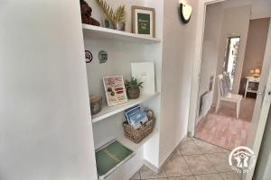 a hallway with white shelves in a house at Brin de bonheur in Évran
