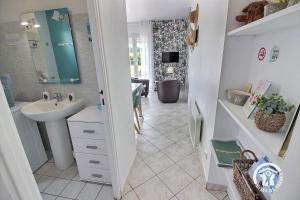a bathroom with a sink and a mirror at Brin de bonheur in Évran +21 photos