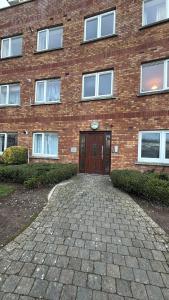 a brick building with a door in front of it at Double room beside tramline in Dublin