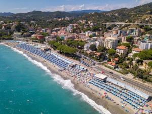 an aerial view of a beach with umbrellas and the ocean at Villetta Brasi in Celle Ligure