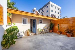 a house with a wooden fence and a patio at Olga Premium Apartments in Limassol