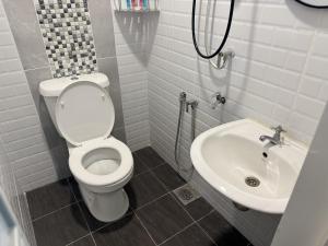 a bathroom with a toilet and a sink at Zetta Roomstay in Kuala Lumpur