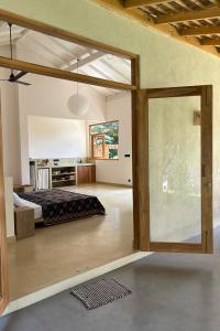 a bedroom with a bed and a sliding glass door at Madi House in Matara