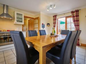 a dining room with a wooden table and chairs at Hazel Lodge in Blairgowrie +16 photos