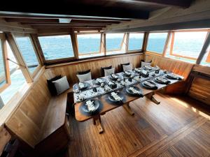 an overhead view of a dining room on a boat at Shared Boat Komodo 3 days 2 Night in Komodo Labuan Bajo Airport +3 photos