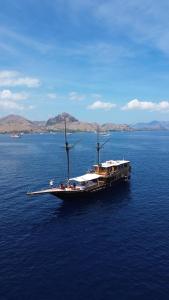 a boat in the middle of a large body of water at Shared Boat Komodo 3 days 2 Night in Komodo Labuan Bajo Airport