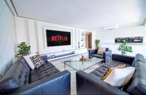 a living room with two couches and a tv at Appartement luxe hivernage in Marrakesh