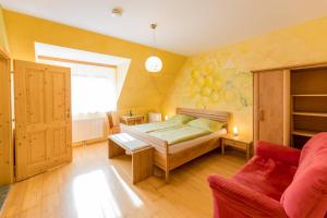 a bedroom with a bed and a couch at Winzerhof Strablegg in Großklein