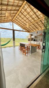 a patio with a table and chairs and a kitchen at Chalé M in Serra do Cipo