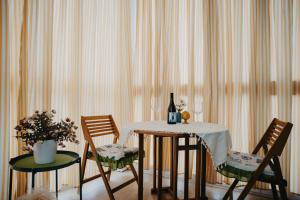 un tavolo con due sedie e una bottiglia di vino di La casa del sole a Molfetta Altre 26 foto