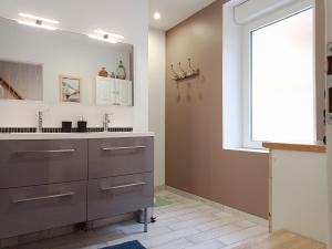a bathroom with a sink and a large mirror at La Filature in Rochesson +27 photos