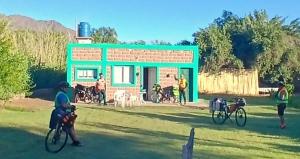 a group of people on bikes in front of a building at Kateké in Tinogasta