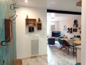 a kitchen and dining room with a table and chairs at La Filature in Rochesson