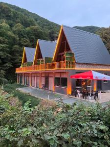 a large wooden house with a deck and a patio at AĞARaN SUİT BUNGALOV in Rize